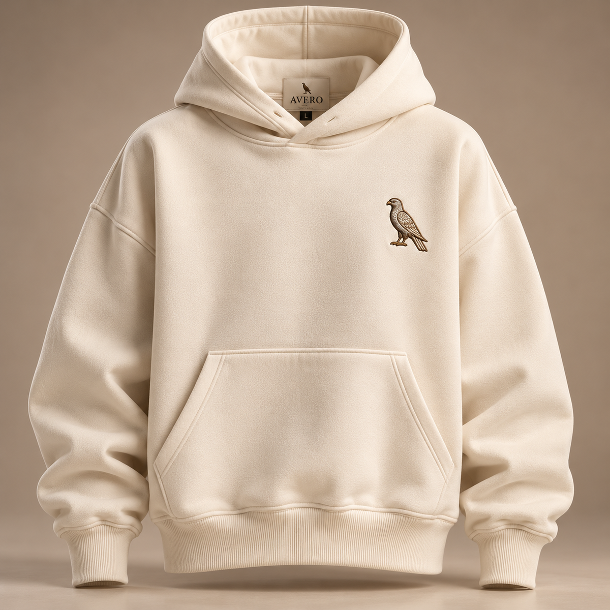 AVERO IVORY oversized hoodie, front, with brown-gold embroidered falcon on the left chest